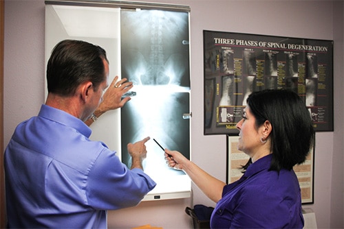 Chiropractor Fountain Valley CA Lysa Stark and Randy Stark Looking over X-Rays